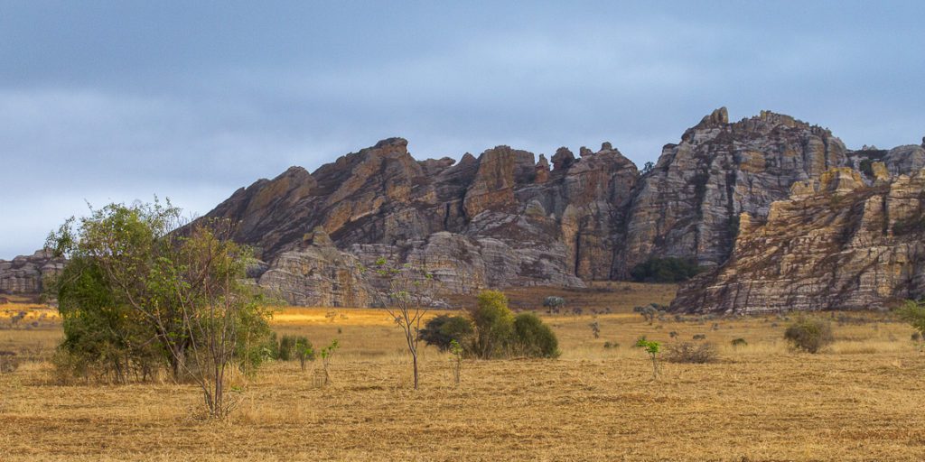 Flat grassland meeting rocky cliff, a common scene in the Madagascar highlands.