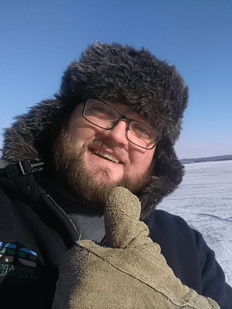 allan saylor gives the camera a thumbs up in a snowy background