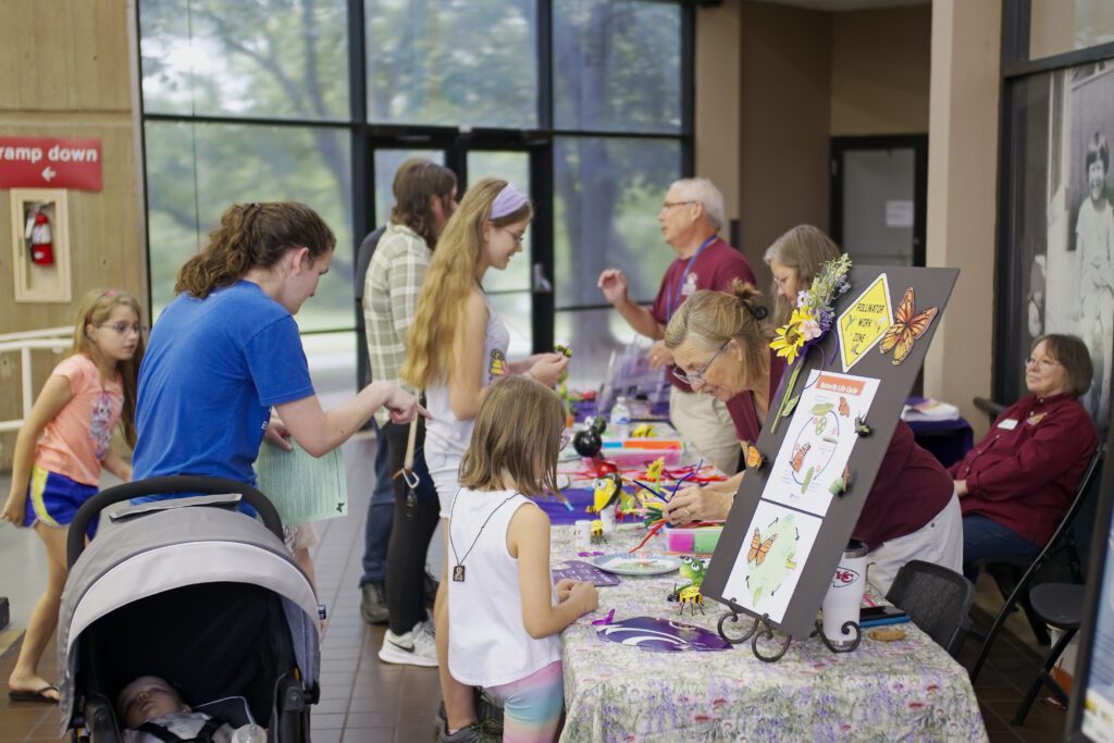 A colorful, playful booth of activities for kids celebrating pollinators.
