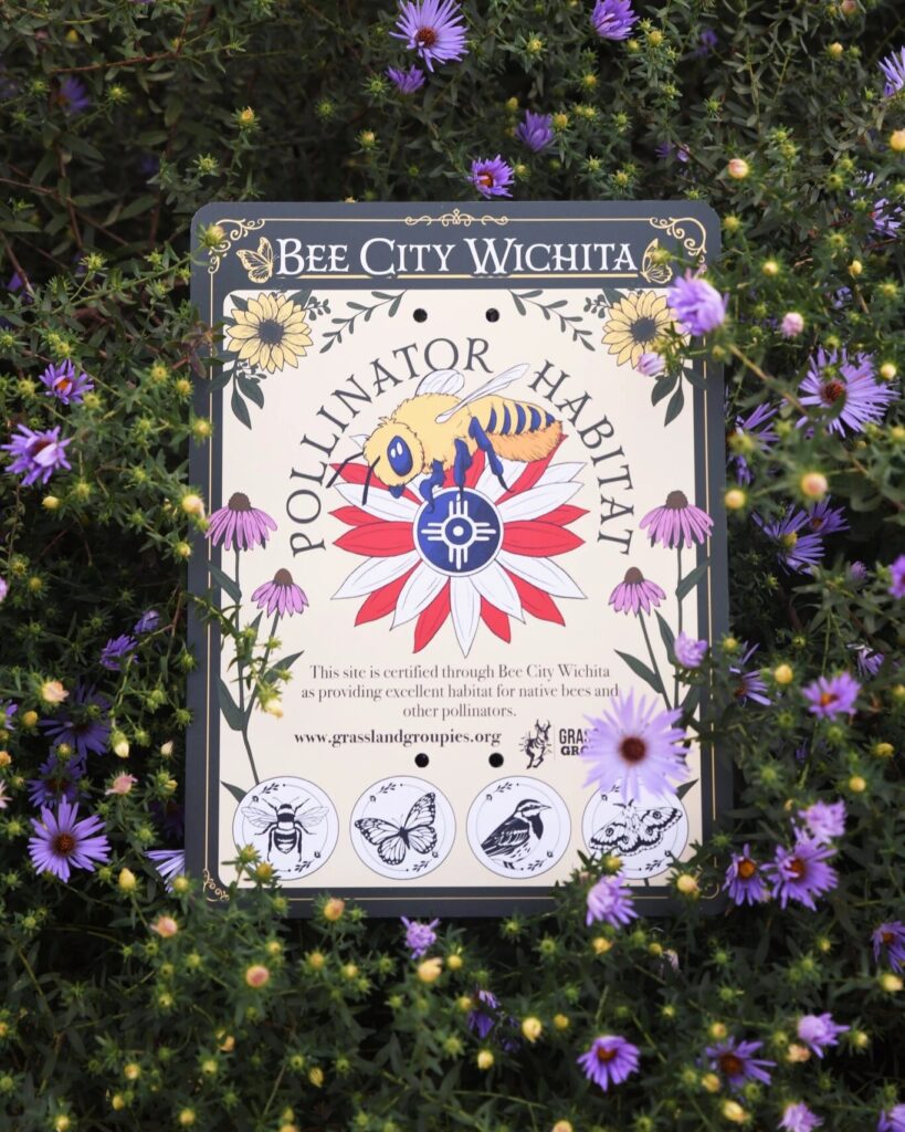 Art deco garden sign with native plant illustrations and Bee City Wichita logo reads "Bee City Wichita Pollinator Habitat" and "this site is certified through Bee City Wichita as providing excellent habitat for native bees and other pollinators." There are four black-and-white illustrations where badges can be placed. Photograph by Anna Petrow