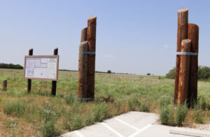 Wooden pillars mark the entrance to the prairie park.