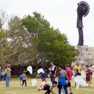 Families catch insects and other bugs under the keeper of the plains.