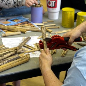Volunteers cut bamboo tubes for the take-home bee hotels.