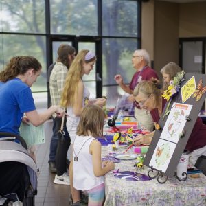 A colorful, playful booth of activities for kids celebrating pollinators.